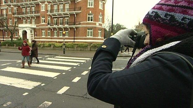 People taking photos on the Abbey Road crossing