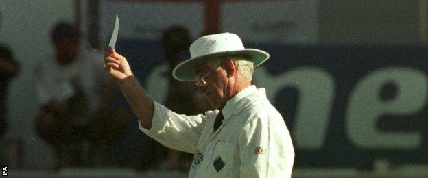 Umpire Cyril Mitchley gives West Indies batsman Philo Wallace a yellow card as a joke in 1998