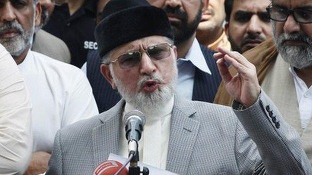 Muhammad Tahirul Qadri, Sufi cleric and leader of political party Pakistan Awami Tehreek (PAT) gestures as he addresses a news conference outside his residence in Lahore August 9