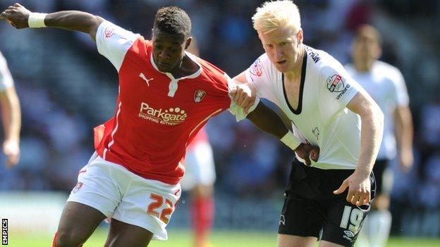 Rotherham United's Kieran Agard (l) and Derby County's Will Hughes battle for possession