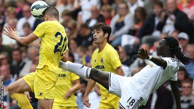 Gabriel Paulista beats Swansea's Bafetimbi Gomis to the ball