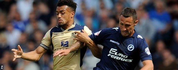 Leeds United's Nicky Ajose (left) and Millwall's Scott McDonald battle for the ball at the New Den