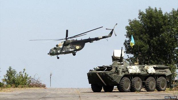 A Ukrainian helicopter and armoured vehicle near Donetsk, 9 August