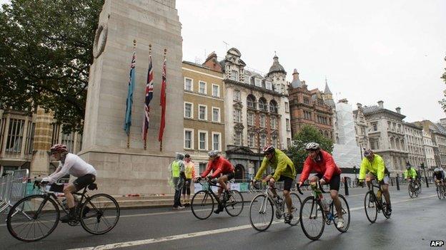 Cyclists ride past the Cenotaph in central London