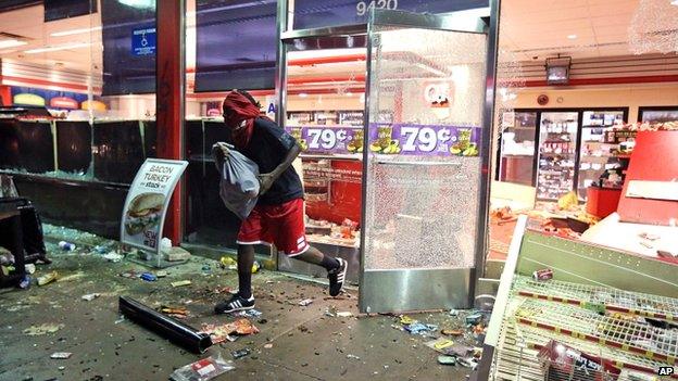 A man leaves a store in Ferguson on Sunday 10 August