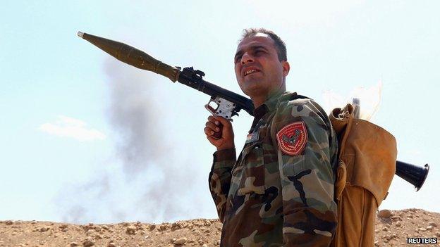 Member of the Kurdish "peshmerga" takes his position holding a RPG launcher during an intensive security deployment against Islamic State militants, on the outskirts of the province of Nineveh