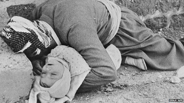 Kurd father holding his baby after Iraqi chemical attack on the city of Halabja, northeastern Iraq