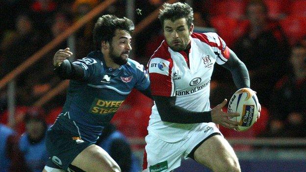 Gareth Owen of the Scarlets is about to tackle Ulster's Jared Payne in last season's game at Parc y Scarlets