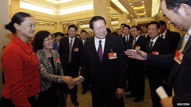 Chinese former Politburo Standing Committee Member Zhou Yongkang shakes hands with delegates as he attends a group discussion of Shaanxi Province during the National People's Congress at the Great Hall of the People in Beijing, in this file photo taken on 12 March, 2011