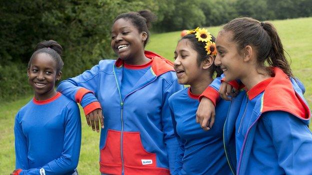 The new Girlguide uniform - blue tshirts and jumpers with red trim.