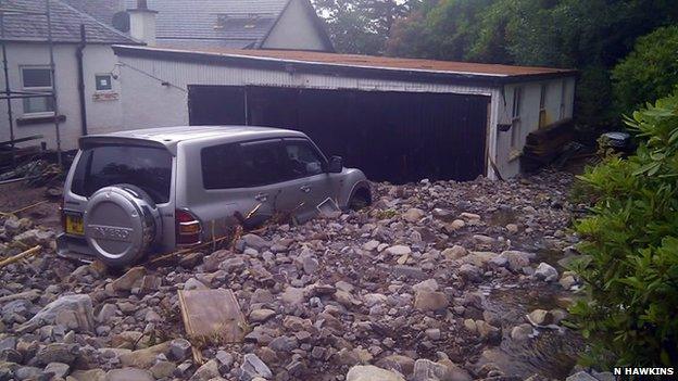 Car in flood debris near Ullapool