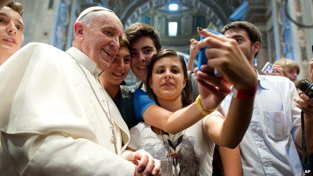 Pope Francis has his picture taken inside St. Peters Basilica with youths from the Italian Diocese of Piacenza (28 August 2013)