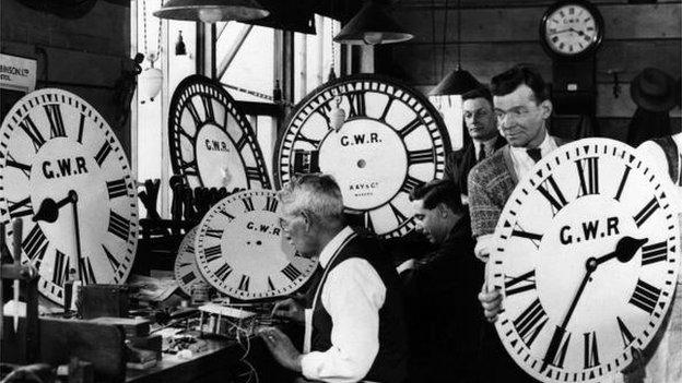 Employees at the Great Western Railway's signal works in Reading test and repair some of the company's many clocks