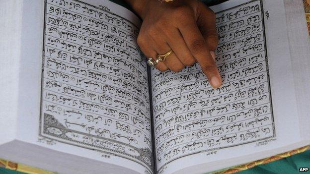 Indian Muslim reading from the holy book