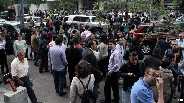 People gather in the street in Quito, after a 5.1-magnitude earthquake (12 August 2014)