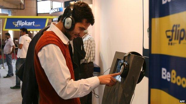 A man browses the Flipkart catalogue in a showroom