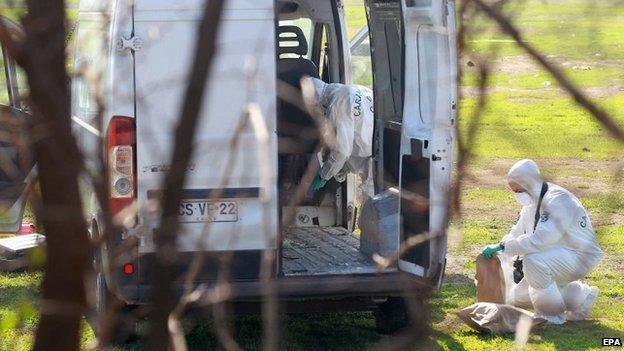 Chilean authorities inspect an abandoned vehicle used in the record robbery on 12 August 2014