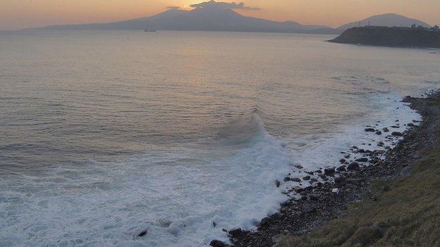 Volcano Mendeleyev is silhouetted against the sunset on Kunashir Island, one of the Kuril Islands,