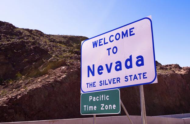 Sign reads "Welcome to Nevada - mountain time zone"