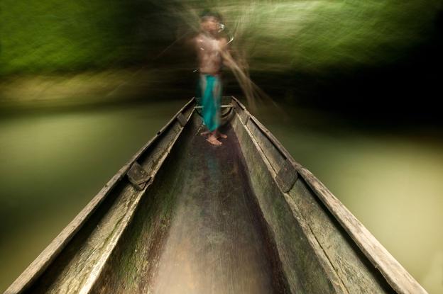 Embera man on boat on Mogue river in the Darien province