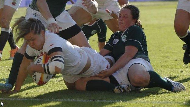 England's Marlie Packer scores a try while Ireland's Gillian Bourke tries to stop her