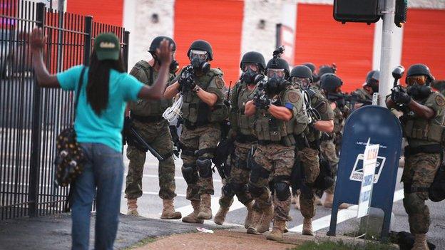 Protester facing police