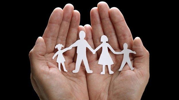 A paper chain in the form of a family of four holding hands