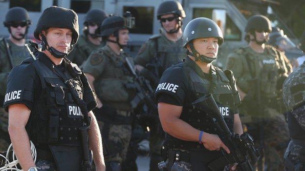 Police in riot gear gather in Ferguson, Missouri.