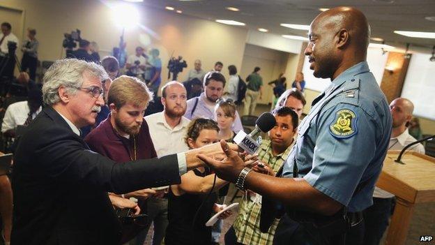 The new man in charge, Capt Ronald Johnson, meets reporters