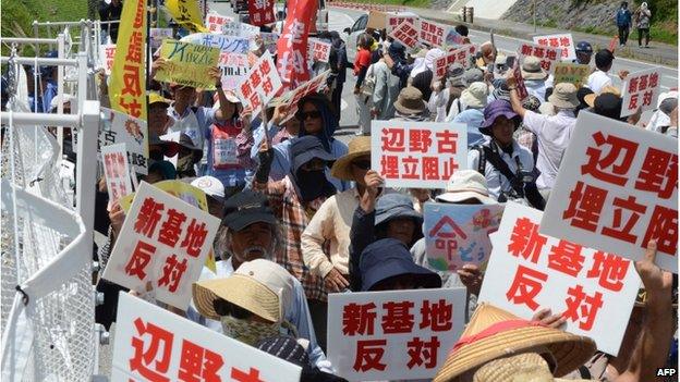 Protesters stage a rally at the gates of Camp Schwab, near the site of the new US military runways in Nago, Okinawa prefecture on 14 August 2014