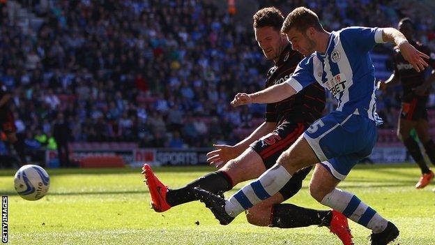 Sean Morrison tries to close down a shot from Callum McManaman