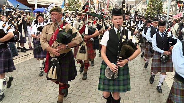 A band of bagpipers march through Aubigny