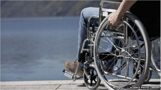 Man in a wheelchair by water