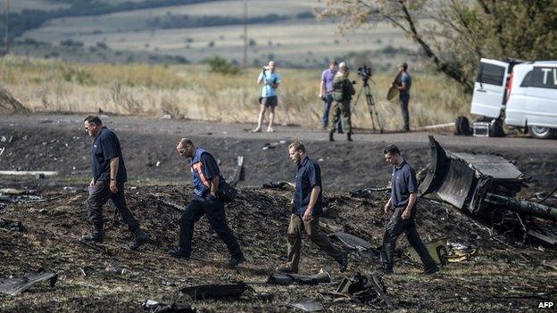 Investigators examine the wreckage near Grabovo, Ukraine