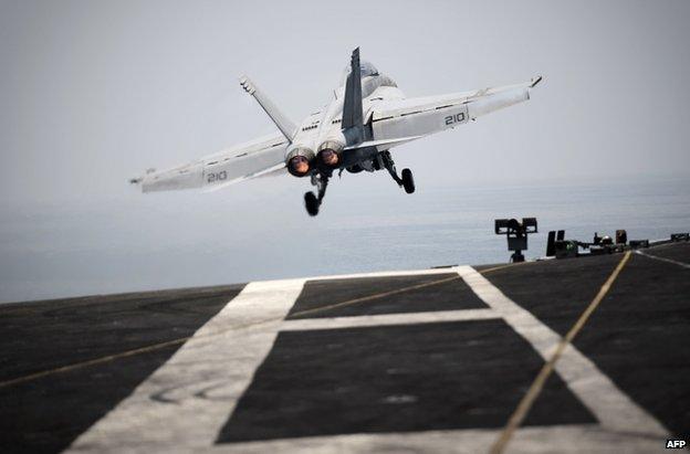 A US warplane takes off from the USS George HW Bush in the Gulf, 15 August