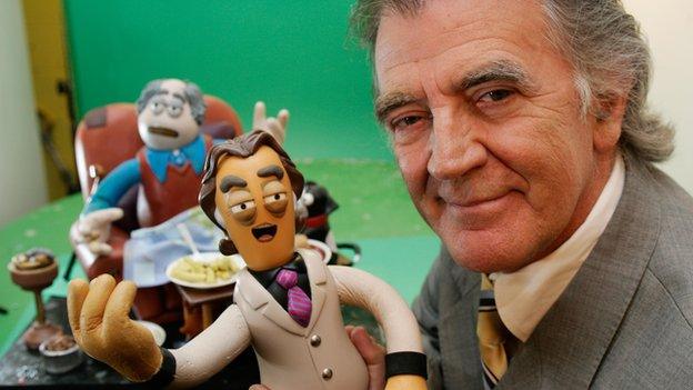 Gerry Anderson posing with a clay animation figure of himself, during the making of the On The Air TV series