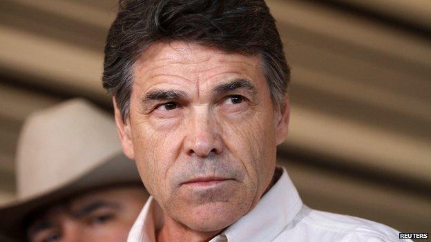 Texas Governor Rick Perry answers questions from the media after taking an aerial tour over the fertilizer plant explosion site in West, Texas in this 19 April 2013 file photo.