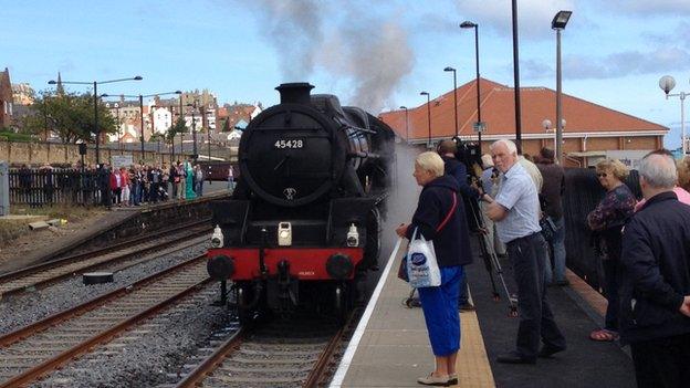 People waiting at the platform for steam train