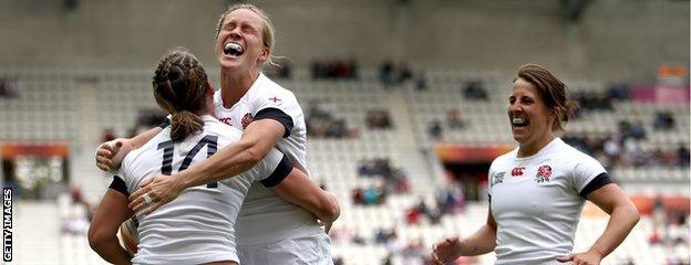 England captain Katy Mclean (R) and Danielle Waterman of England (C) celebrate with Katherine Merchant of England (L)