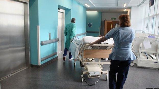 Nurses pushing a bed in an hospital