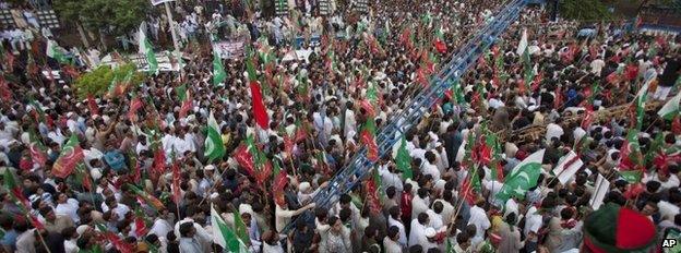 Supporters of Pakistan's cricketer-turned-politician Imran Khan cheer their leader during an anti government rally in Islamabad, Pakistan, Saturday, Aug. 16, 2014