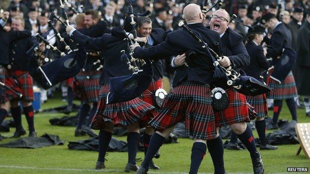 Members of the Field Marshall Montgomery Pipe Band react to winning the annual World Pipe Band Championships at Glasgow Green