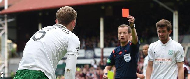 Willie Collum sends off Hibs midfielder Scot Robertson for bringing down Prince Buaben in the box