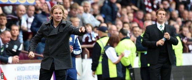 Hearts head coach Robbie Neilson guides his team at Tynecastle as Hibs manager Alan Stubbs looks on