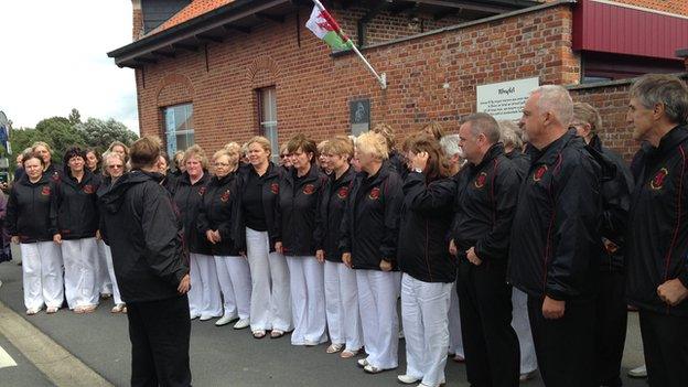 Cor Rygbi Gogledd Cymru at the site of Hedd Wyn's plaque in Langemark where they performed Calon Lan