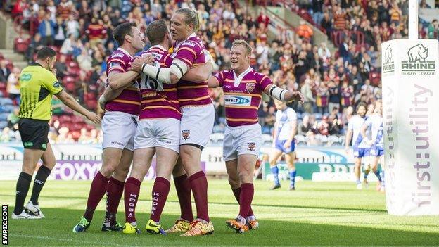 Huddersfield's Larne Patrick is congratulated on scoring against Widnes.