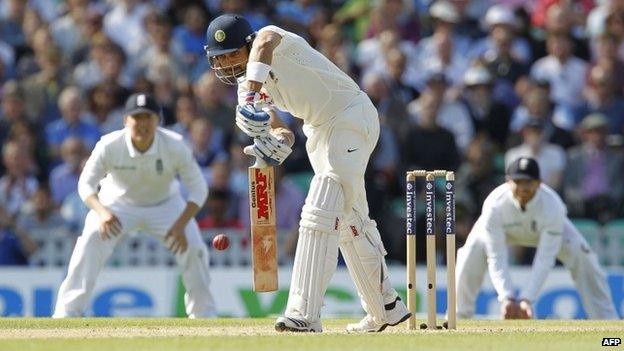 Virat Kohli is caught out by Alastair Cook for 20 runs during play on the third day of the fifth cricket Test match at The Oval in London on August 17, 2014