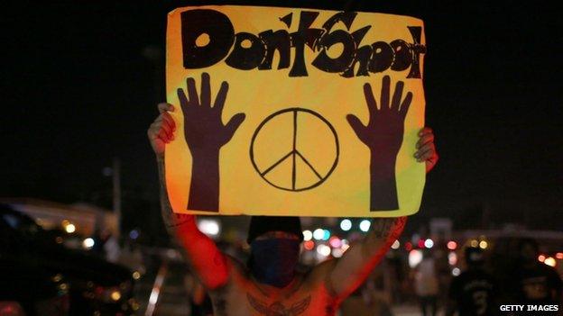 Protester in Ferguson holds up a 'Don't shoot' sign (17 August 2014)