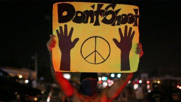 Protester in Ferguson holds up a 'Don't shoot' sign (17 August 2014)