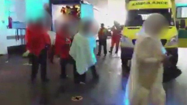 Still from video showing stowaways being aided near container at Tilbury Docks on 16 August 2014